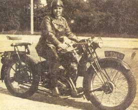 Bet van Beeren in black leather on her bike; she ran Amsterdam gay bar 't Mandje